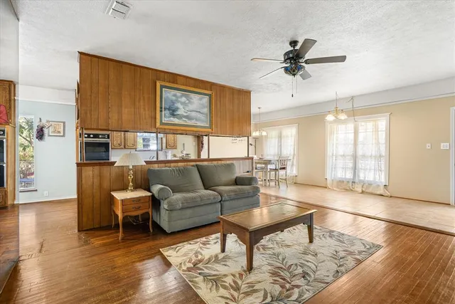 a living room with furniture and a wooden floor