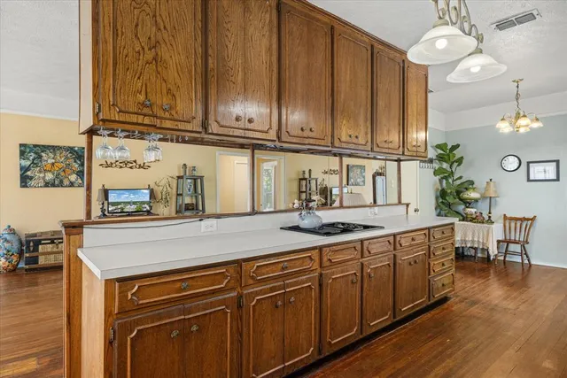 a kitchen with stainless steel appliances granite countertop wooden cabinets a sink and dishwasher