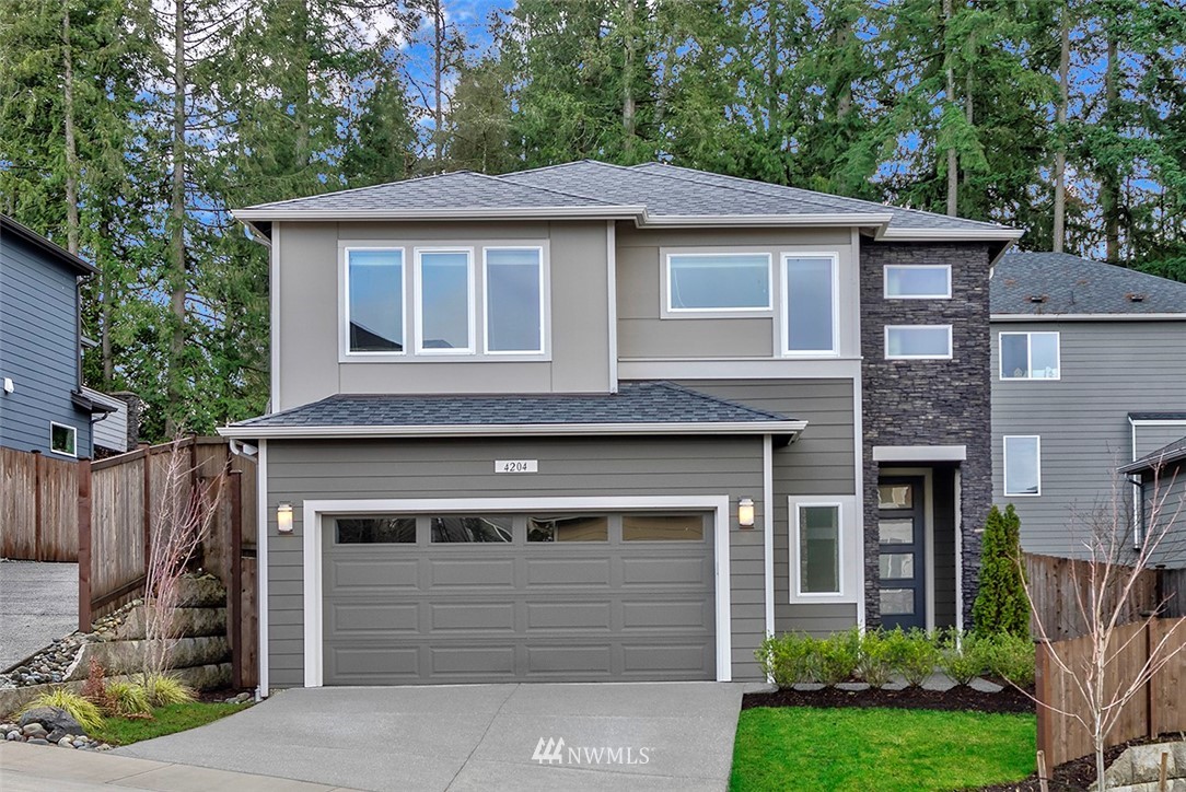 4204 223rd Place Southeast Bothell, WA 98021 - Photo 1 of 23 a front view of a house with a garden