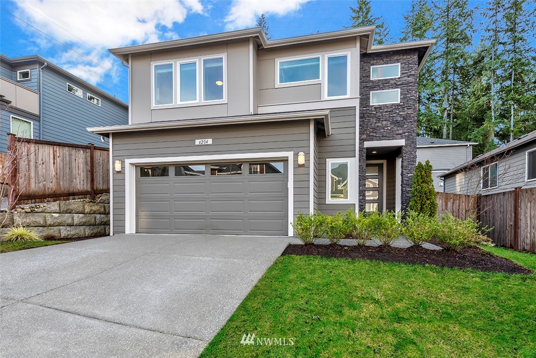 4204 223rd Place Southeast Bothell, WA 98021 - Photo 2 of 23 a front view of a house with a yard and garage