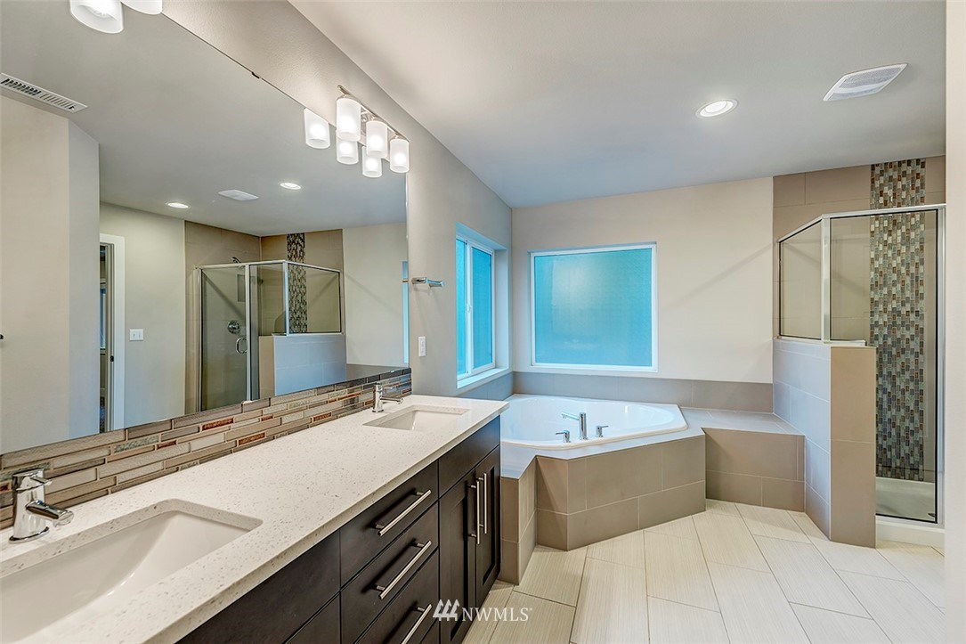 4204 223rd Place Southeast Bothell, WA 98021 - Photo 16 of 23 a bathroom with a sink a large mirror and a bathtub