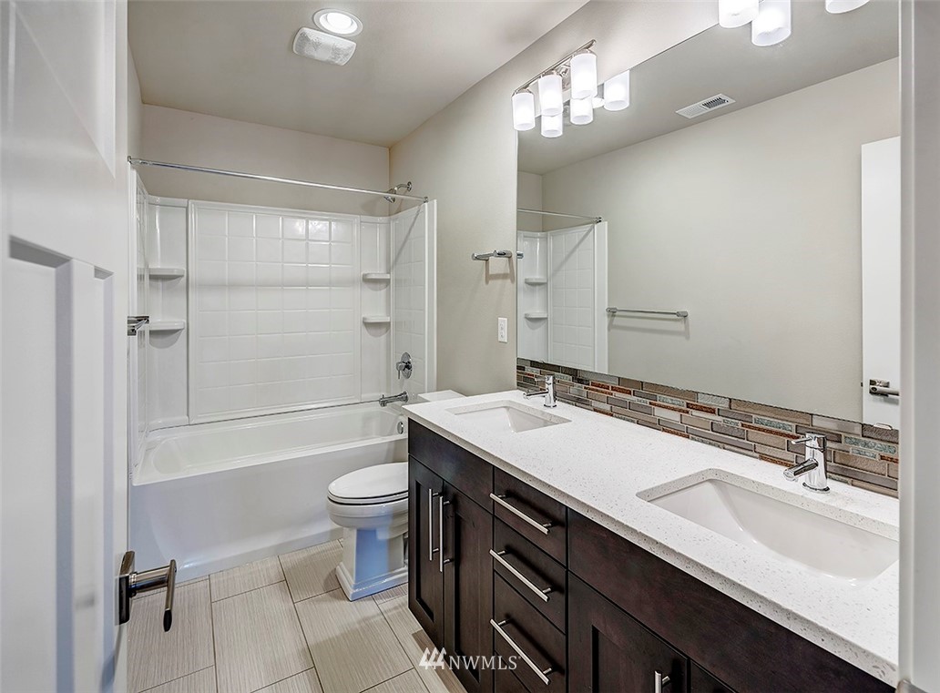 4204 223rd Place Southeast Bothell, WA 98021 - Photo 20 of 23 a bathroom with a sink a toilet a mirror and shower
