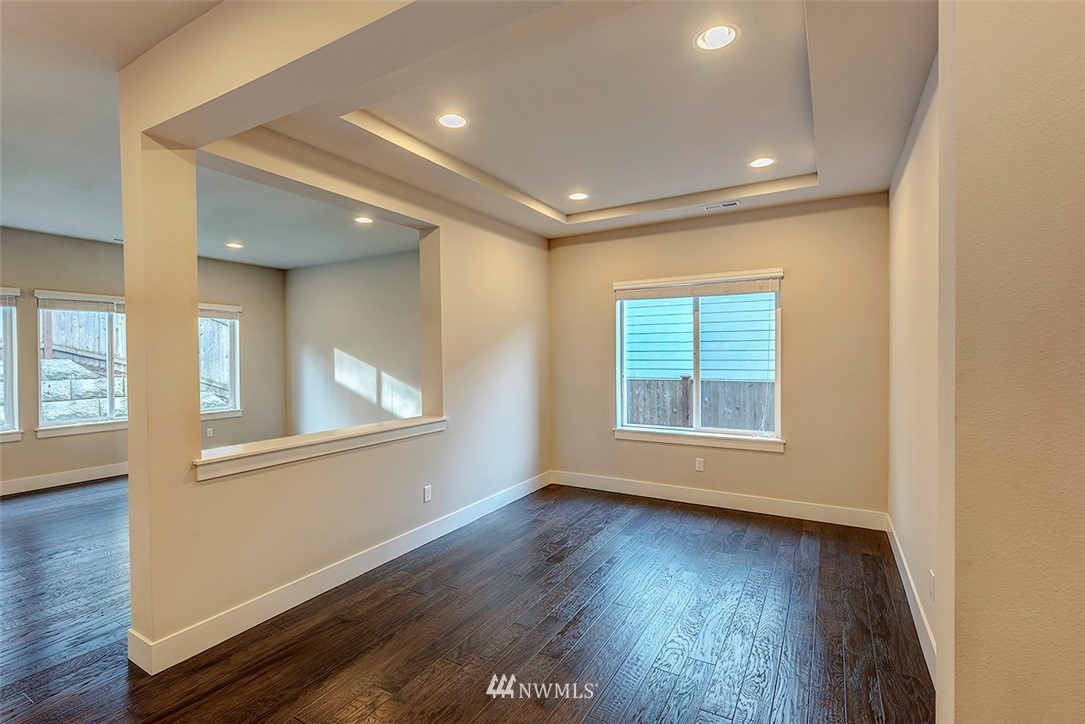 4204 223rd Place Southeast Bothell, WA 98021 - Photo 4 of 23 an empty room with wooden floor and windows