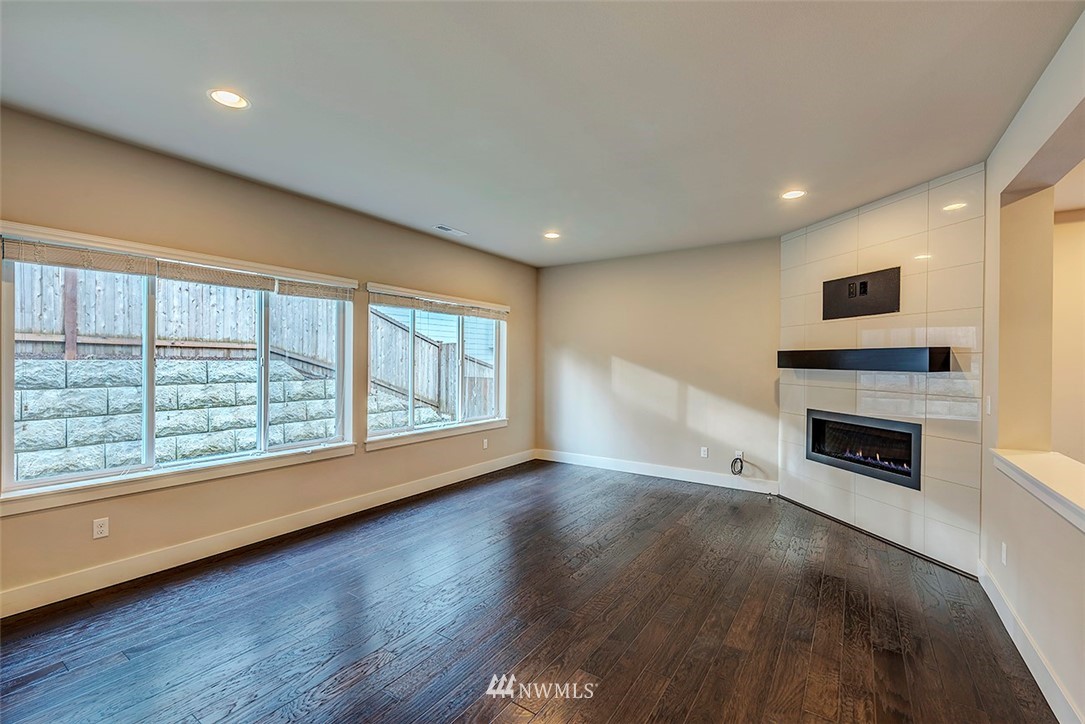4204 223rd Place Southeast Bothell, WA 98021 - Photo 5 of 23 a view of an empty room with a fireplace and a window