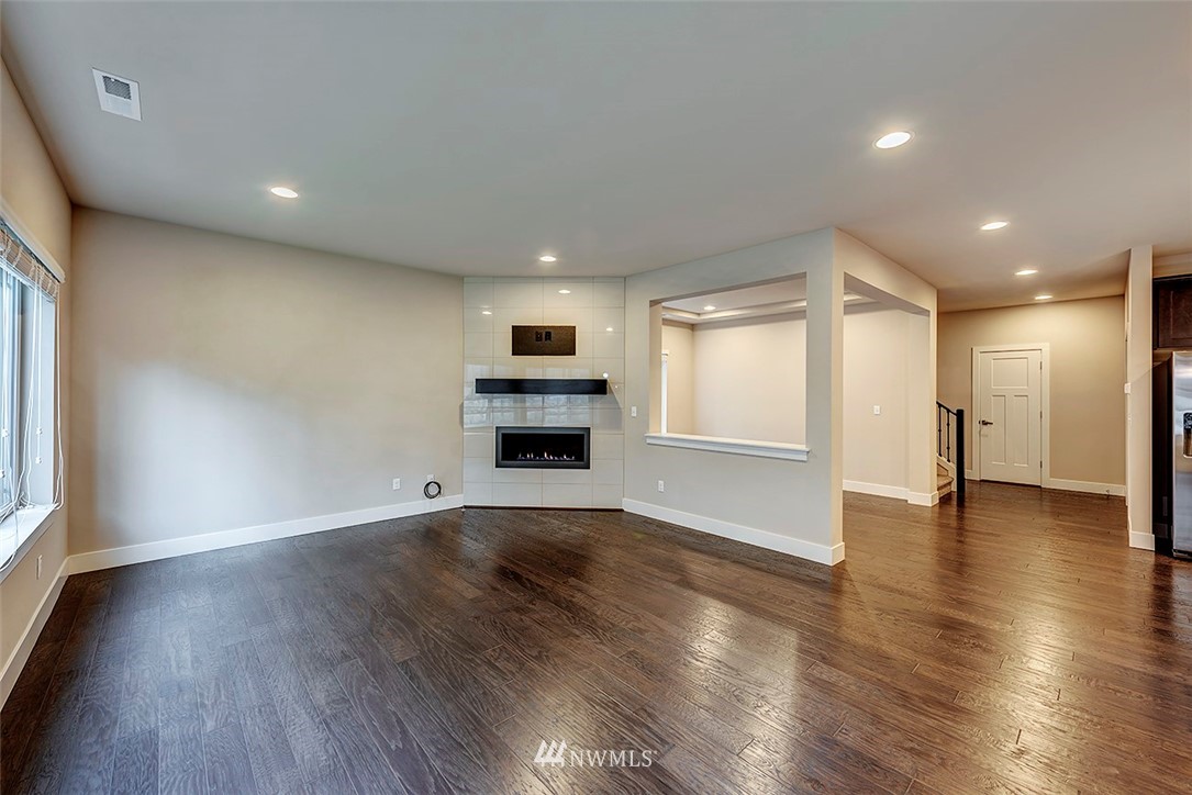 4204 223rd Place Southeast Bothell, WA 98021 - Photo 6 of 23 a view of an empty room with wooden floor and a window