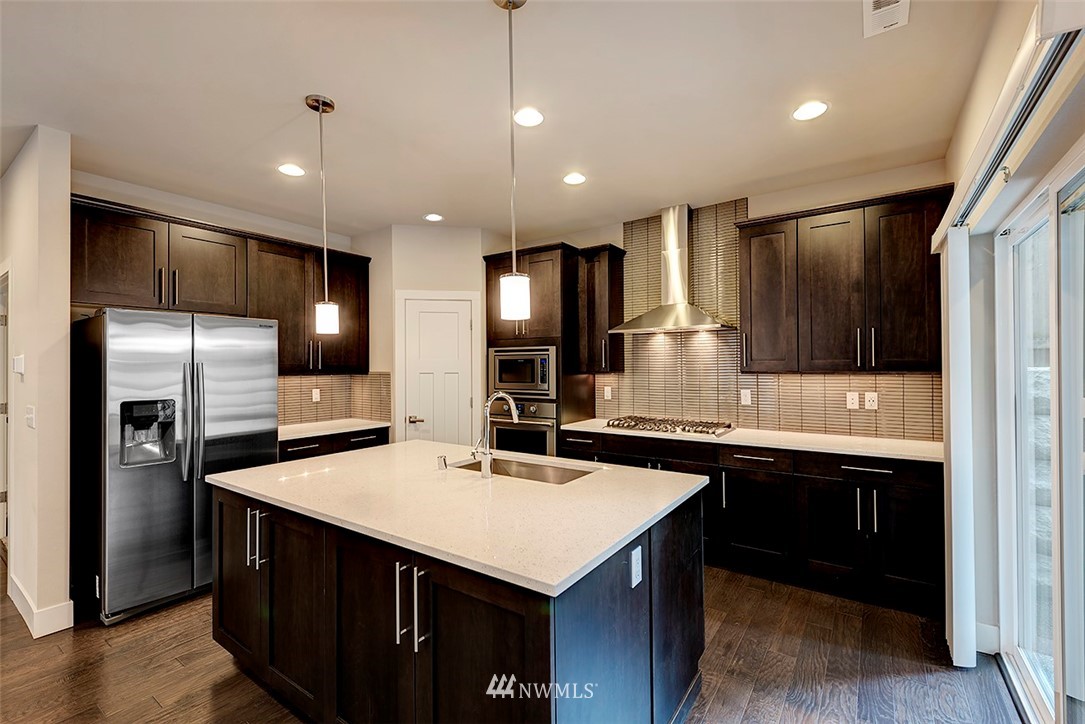 4204 223rd Place Southeast Bothell, WA 98021 - Photo 8 of 23 a kitchen with counter top space cabinets and stainless steel appliances