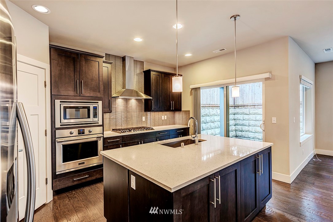 4204 223rd Place Southeast Bothell, WA 98021 - Photo 9 of 23 a kitchen with kitchen island a sink appliances and cabinets