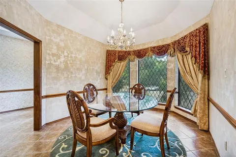 a view of a dining room with furniture and a chandelier