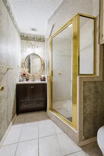 a bathroom with a sink a mirror and a shower