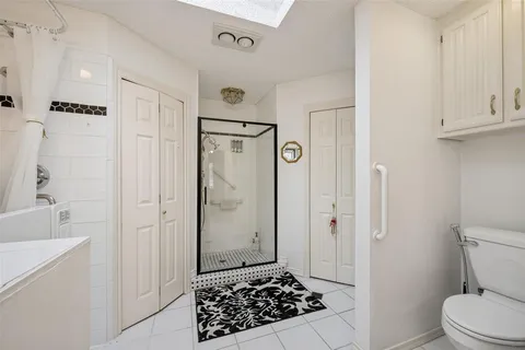 a bathroom with a shower toilet and sink