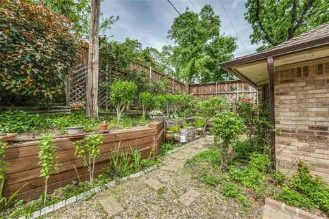 a view of a chair and table in backyard of the house