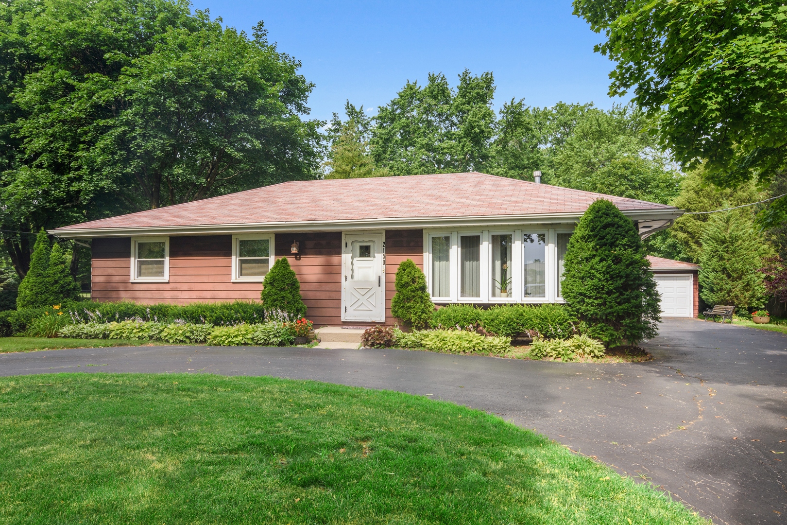 2150 Shermer Road Northbrook, IL 60062 - Photo 1 of 24 a front view of a house with a garden and yard