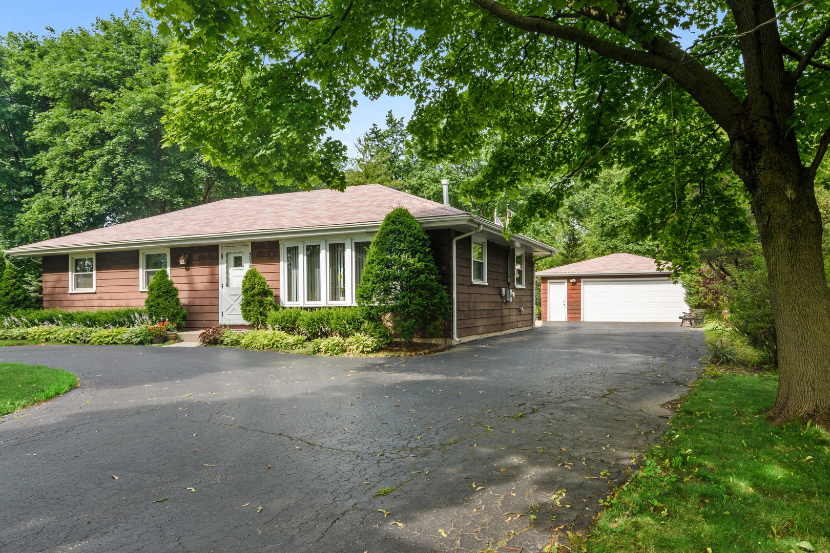 2150 Shermer Road Northbrook, IL 60062 - Photo 2 of 24 a front view of a house with a garden