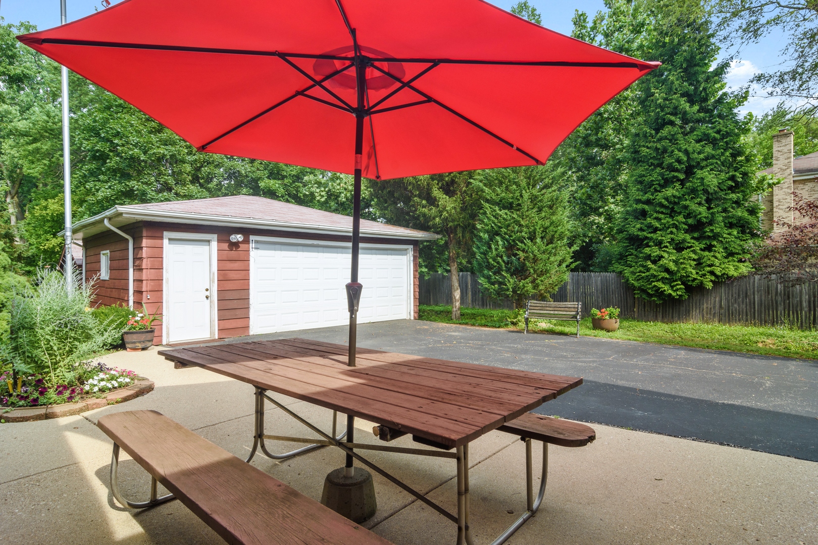 2150 Shermer Road Northbrook, IL 60062 - Photo 16 of 24 a table and chairs under an umbrella in backyard of house