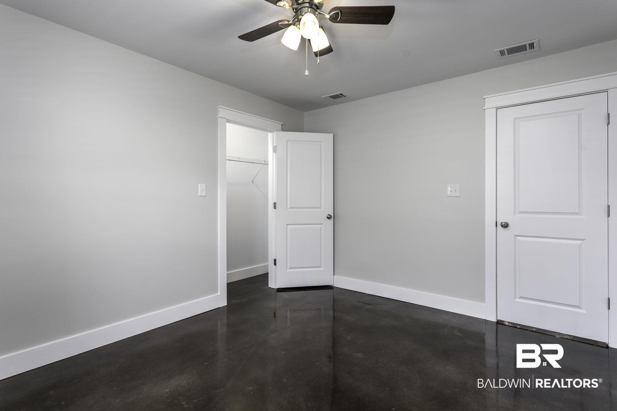 17126 Sugar Loop Foley, AL 36535 - Photo 19 of 28 Unfurnished bedroom with concrete floors and a ceiling fan