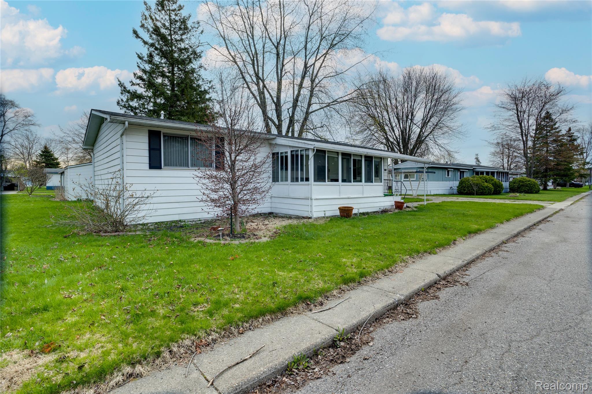3333 Ravenswood Road Marysville, MI 48040 - Photo 2 of 25 View of front facade with a front lawn and a sunroom