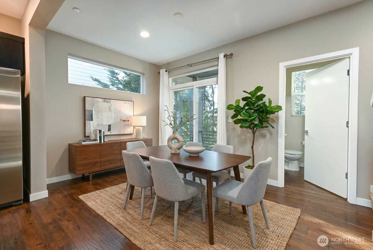 13724 Ash Way, Unit C1 Everett, WA 98204 - Photo 15 of 36 a dining room with furniture a rug and a potted plant