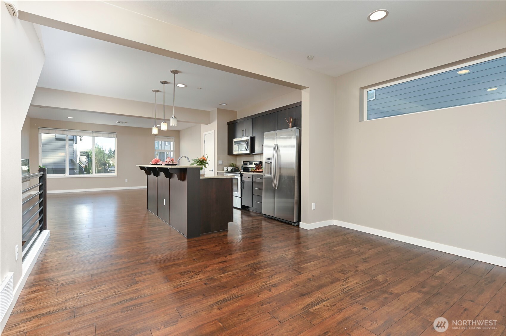 13724 Ash Way, Unit C1 Everett, WA 98204 - Photo 17 of 36 a view of a kitchen with a refrigerator a stove top oven and wooden floor