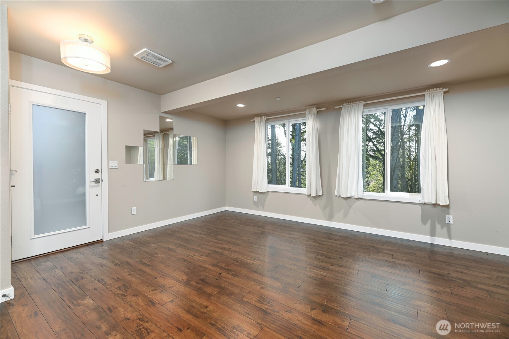13724 Ash Way, Unit C1 Everett, WA 98204 - Photo 5 of 36 a view of an empty room with wooden floor and a window
