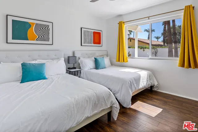 a bedroom with bed and painting on the wall