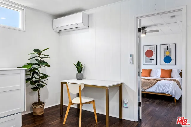 a bed room with furniture and a potted plant