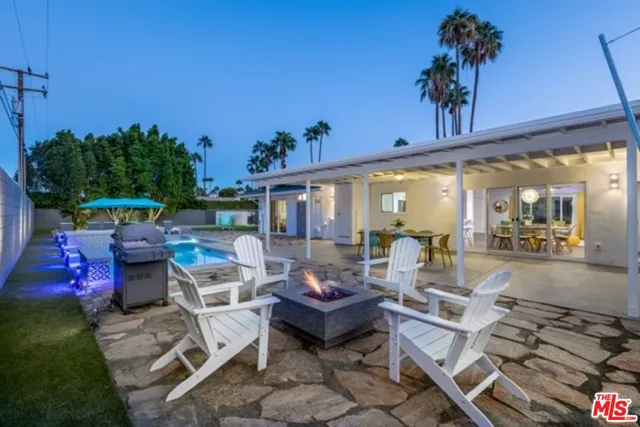 a view of a patio with table and chairs potted plants with sky view