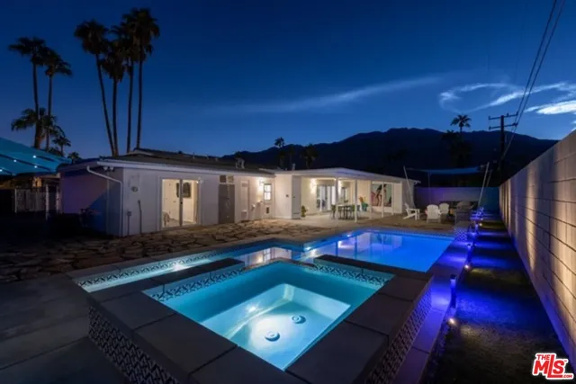 a view of a house with pool and a yard