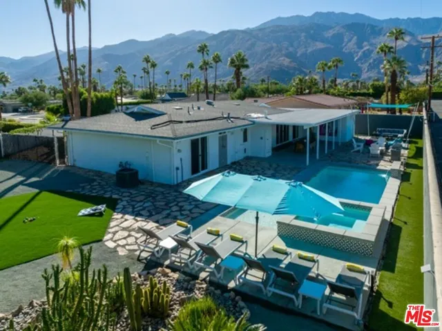 an aerial view of a house having yard patio and mountain view