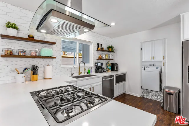 a kitchen with stainless steel appliances granite countertop a stove and a refrigerator