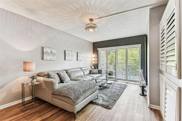 a bedroom with a bed table and a chandelier