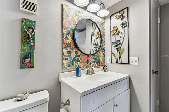 a view of a balcony with chair and potted plants