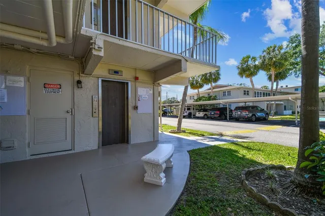 a view of a livingroom with furniture and a book shelf
