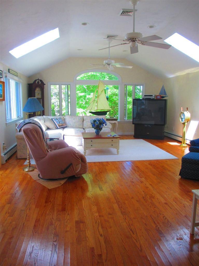 52 Thread Needle Lane Centerville, MA 02632 - Photo 12 of 32 a living room with furniture and a large window