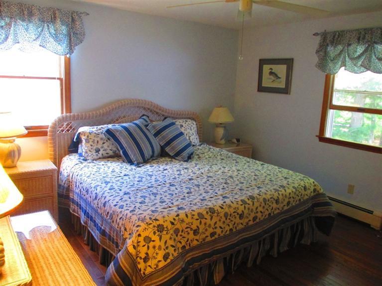 52 Thread Needle Lane Centerville, MA 02632 - Photo 14 of 32 a bedroom with a bed and wooden floor