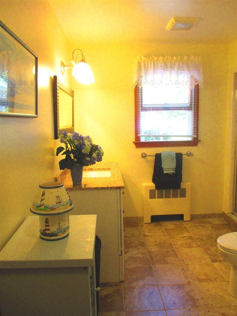 52 Thread Needle Lane Centerville, MA 02632 - Photo 17 of 32 a bathroom with a sink and a mirror