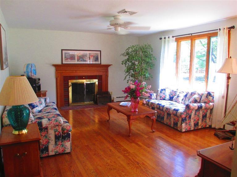 52 Thread Needle Lane Centerville, MA 02632 - Photo 4 of 32 a living room with furniture and a fireplace