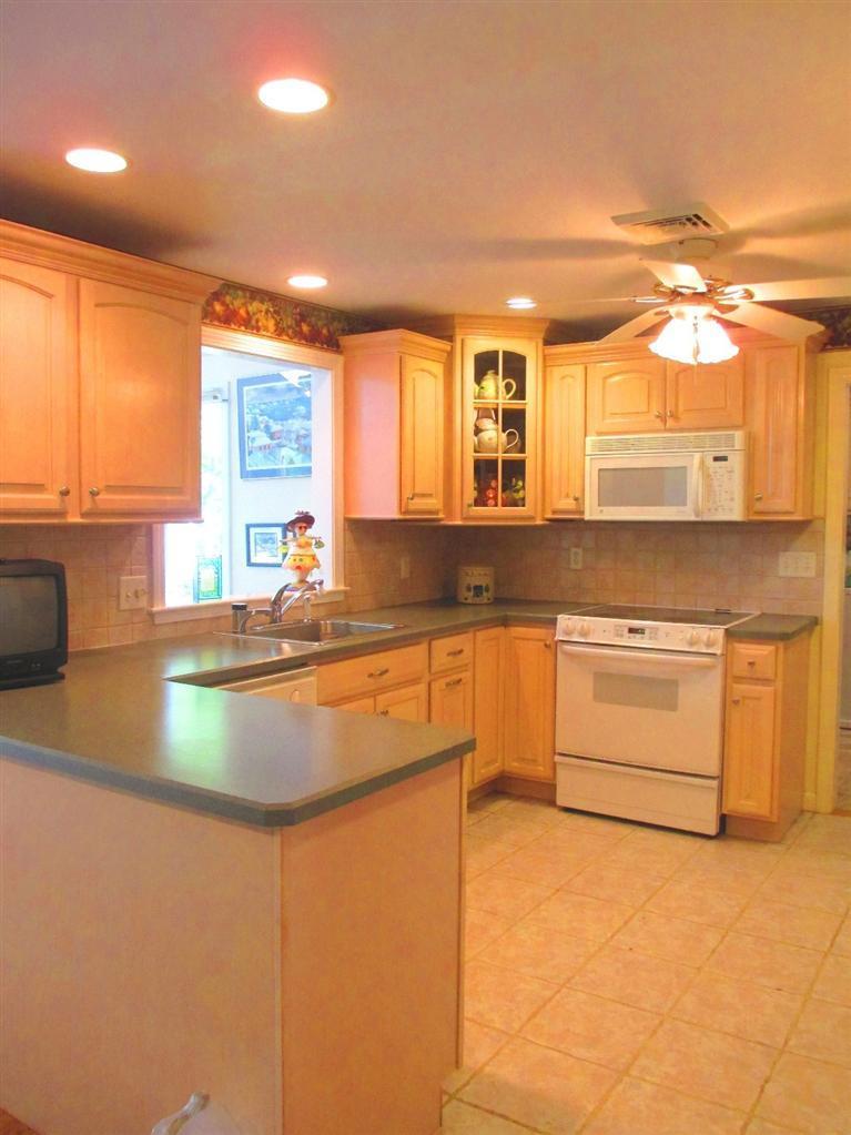 52 Thread Needle Lane Centerville, MA 02632 - Photo 9 of 32 a kitchen with stainless steel appliances granite countertop a sink and a stove