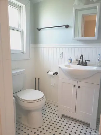 a bathroom with a sink a toilet and a shower