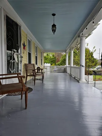 a view of empty room with wooden floor and windows