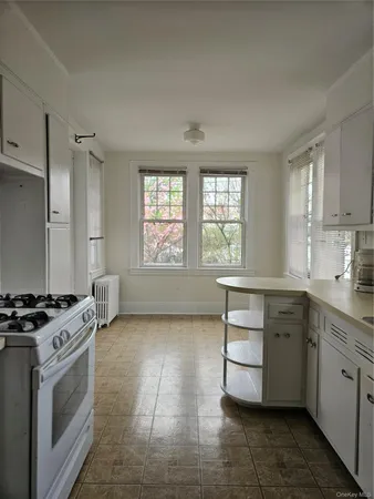a kitchen with a stove sink and cabinets