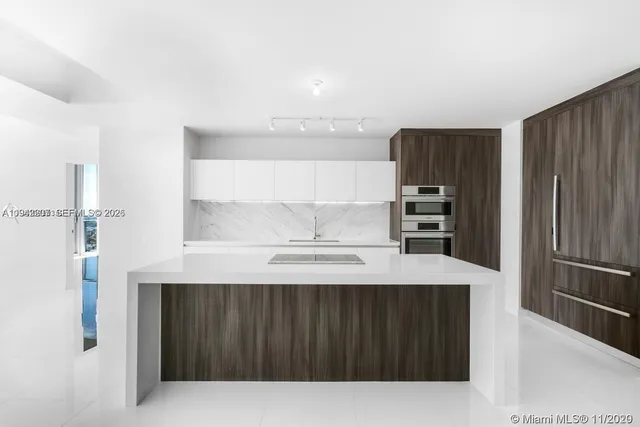 a kitchen with a refrigerator and cabinets