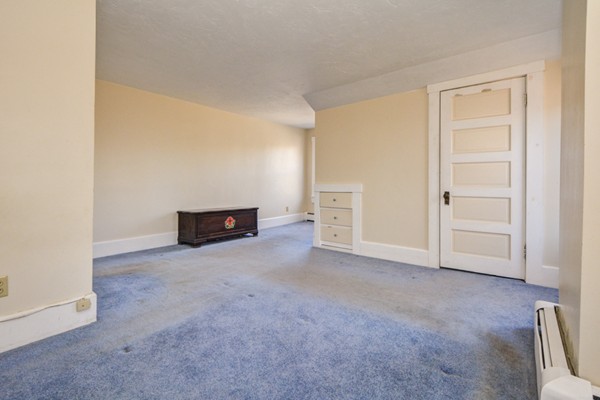 50 Lancaster Road Shirley, MA 01464 - Photo 24 of 30 an empty room with a fireplace and cabinet