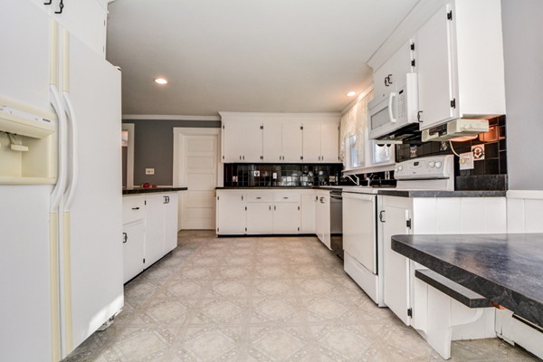 50 Lancaster Road Shirley, MA 01464 - Photo 10 of 30 a kitchen with stainless steel appliances granite countertop a stove top oven a sink a refrigerator and white cabinets