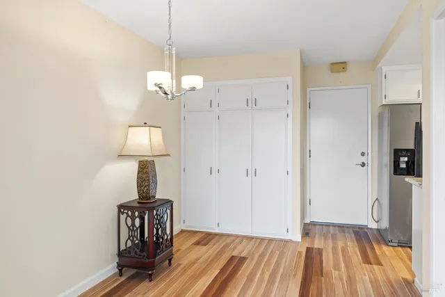 a view of a room with wooden floor closet and a ceiling fan