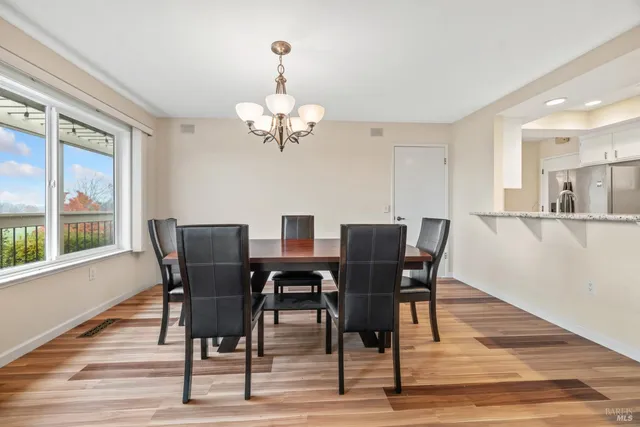 a view of a dining room with furniture wooden floor and chandelier