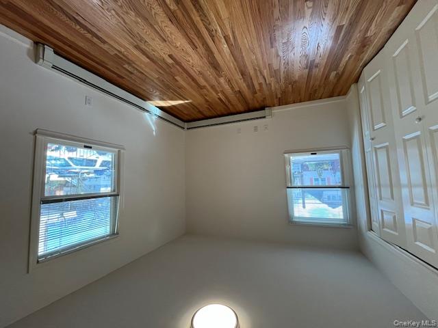 46 Firwood Road, Unit 1 Port Washington, NY 11050 - Photo 11 of 16 Unfurnished bedroom with a baseboard heating unit, light wood-style flooring, and a closet