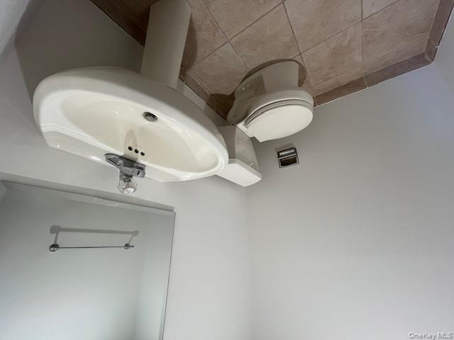 46 Firwood Road, Unit 1 Port Washington, NY 11050 - Photo 4 of 16 Bathroom featuring toilet and light tile patterned floors