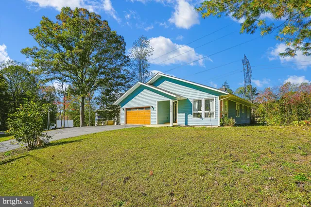 a front view of house with yard and trees