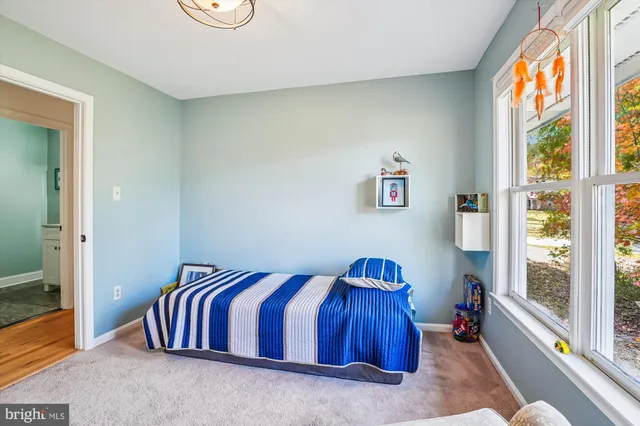 a spacious bedroom with a bed and a window
