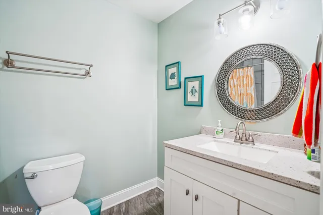 a bathroom with a toilet a sink and a mirror